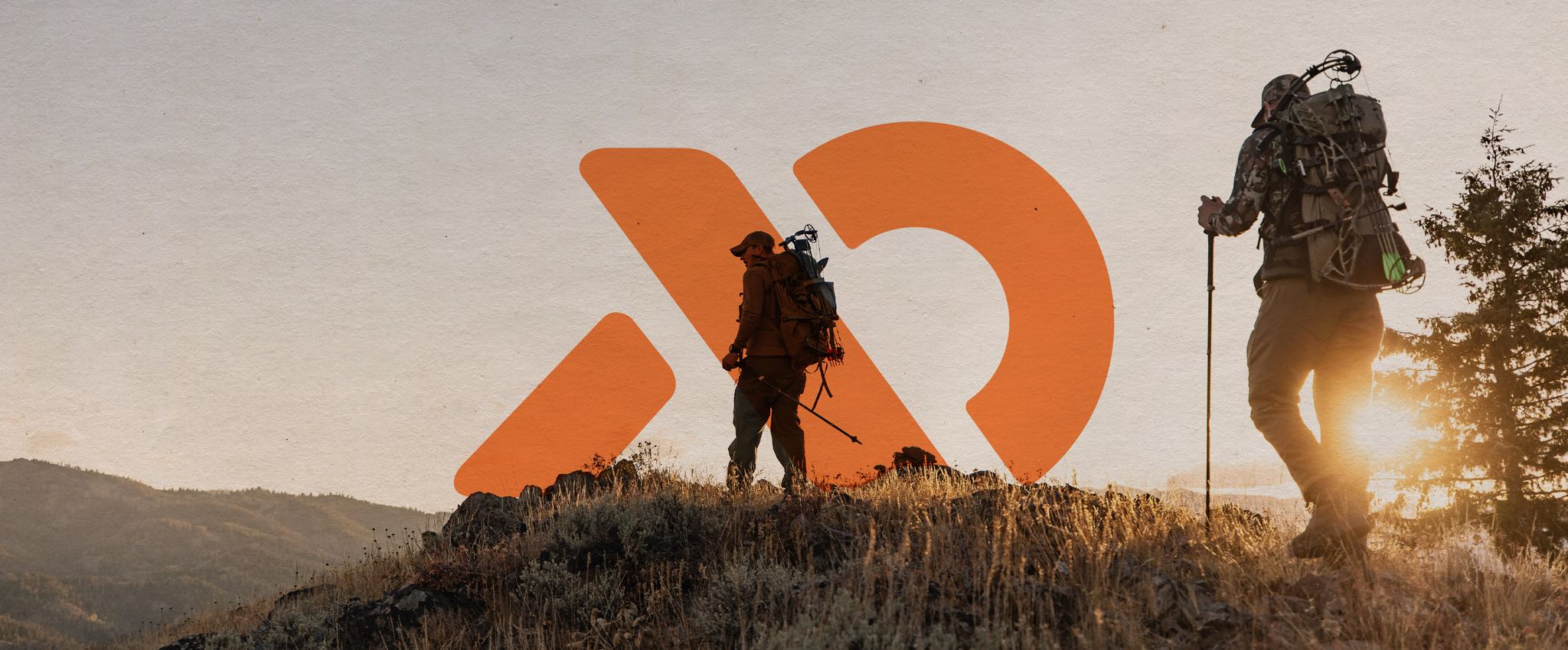 Two hikers on a ridgetop with the First Lite logo overlayed in the background