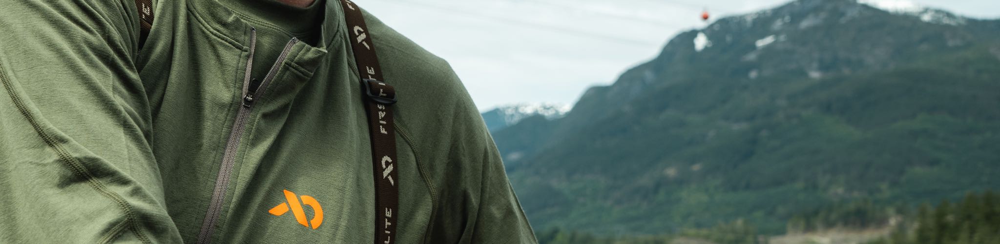 Close up of a wool baselayer with mountains in the background