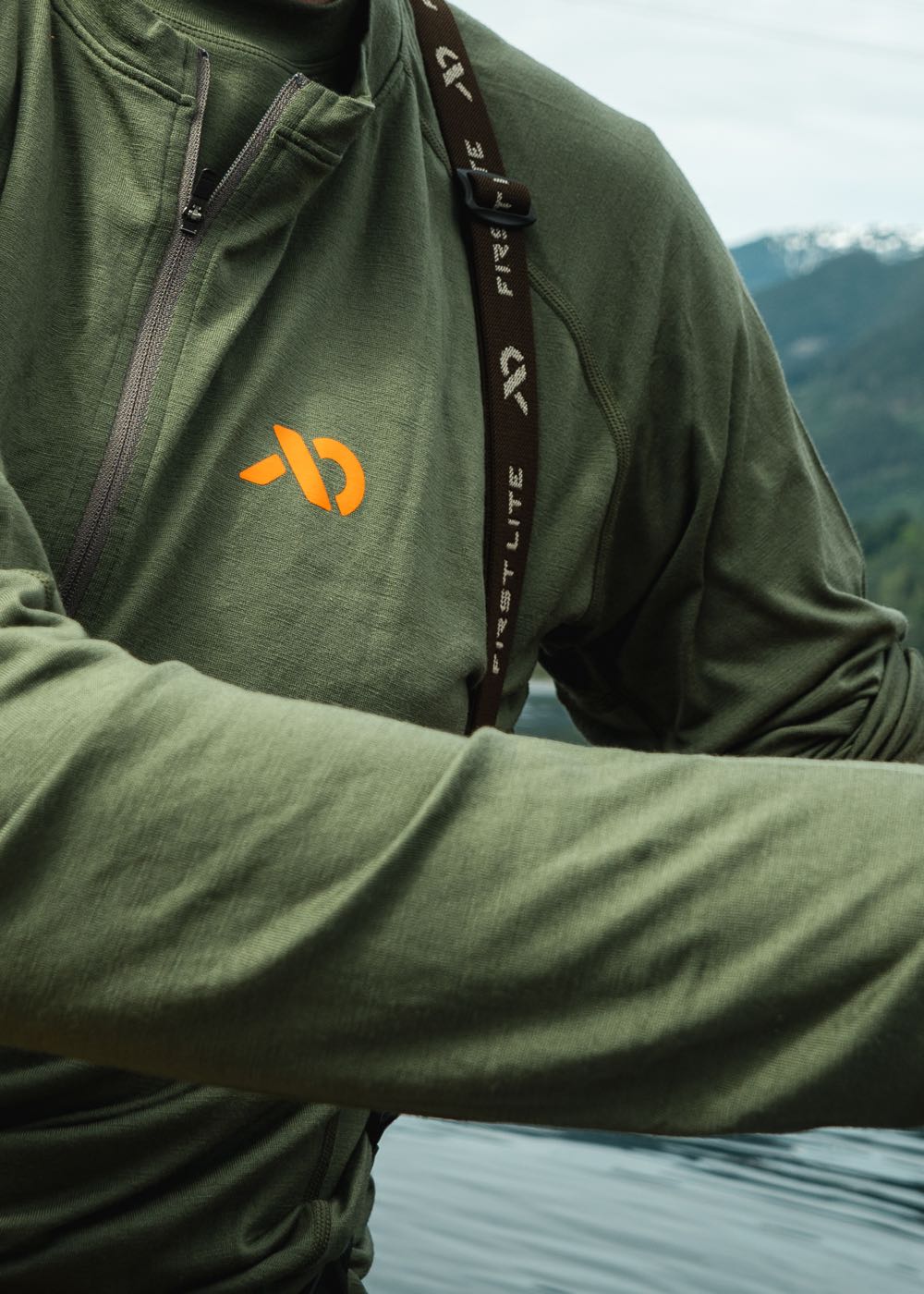 Close up of a wool baselayer with mountains in the background