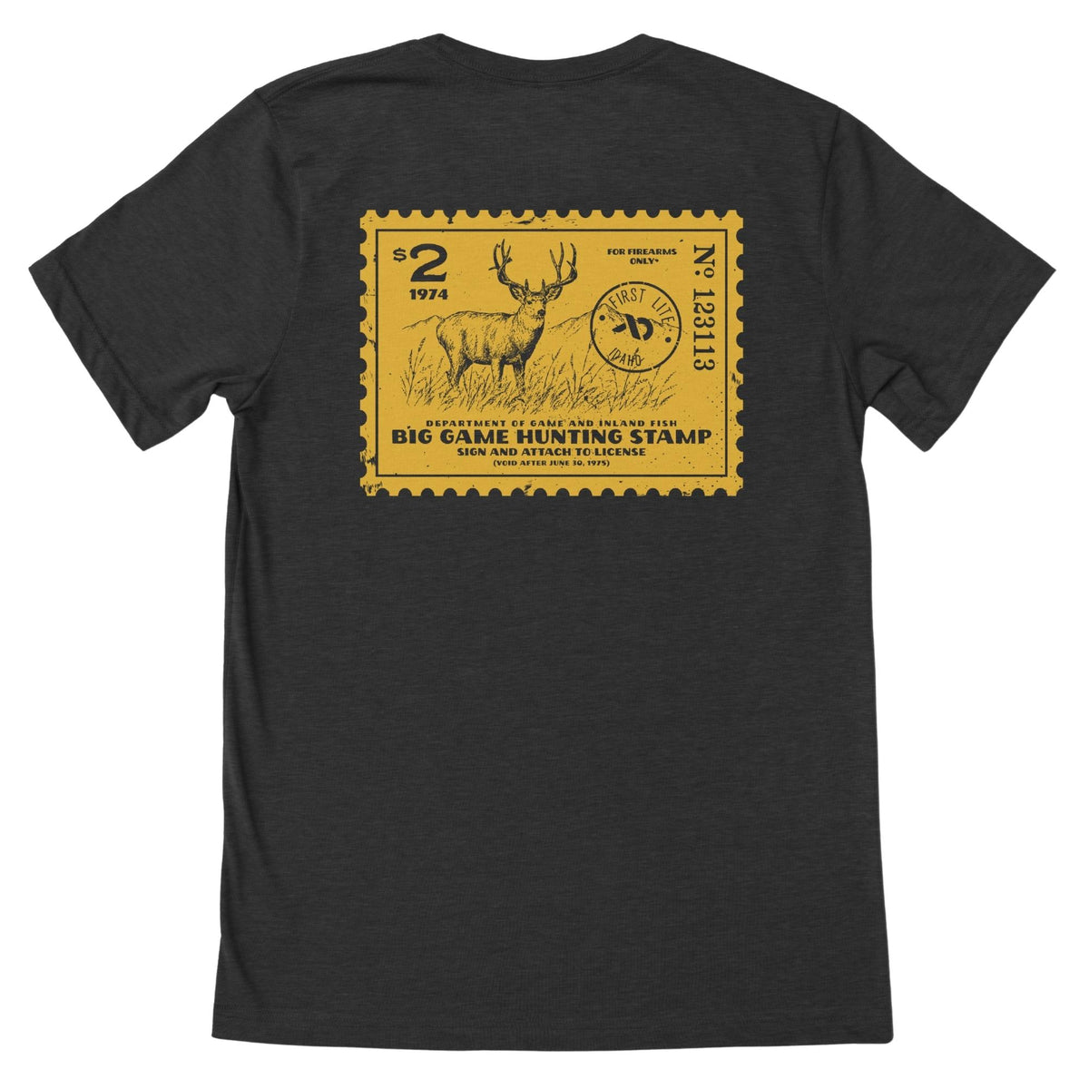 Charcoal heather T-shirt featuring a yellow postage stamp of a deer and mountains in the background, FIRST LITE branding and the text "DEPARTMENT OF GAME AND INLAND FISH BIG GAME HUNTING STAMP (VOID AFTER JUNE 30, 1975)".