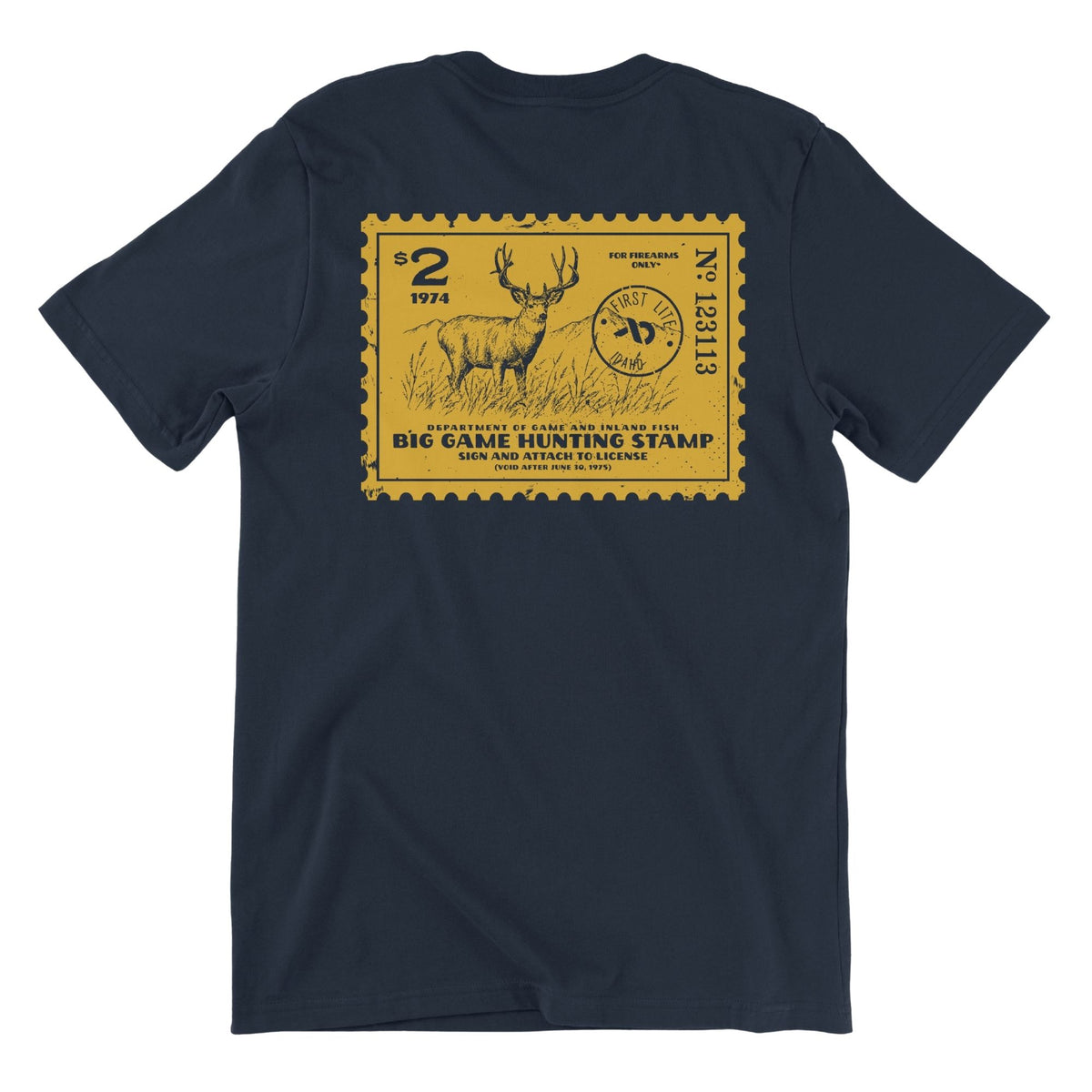Navy T-shirt featuring a yellow postage stamp of a deer and mountains in the background, FIRST LITE branding and the text "DEPARTMENT OF GAME AND INLAND FISH BIG GAME HUNTING STAMP (VOID AFTER JUNE 30, 1975)".