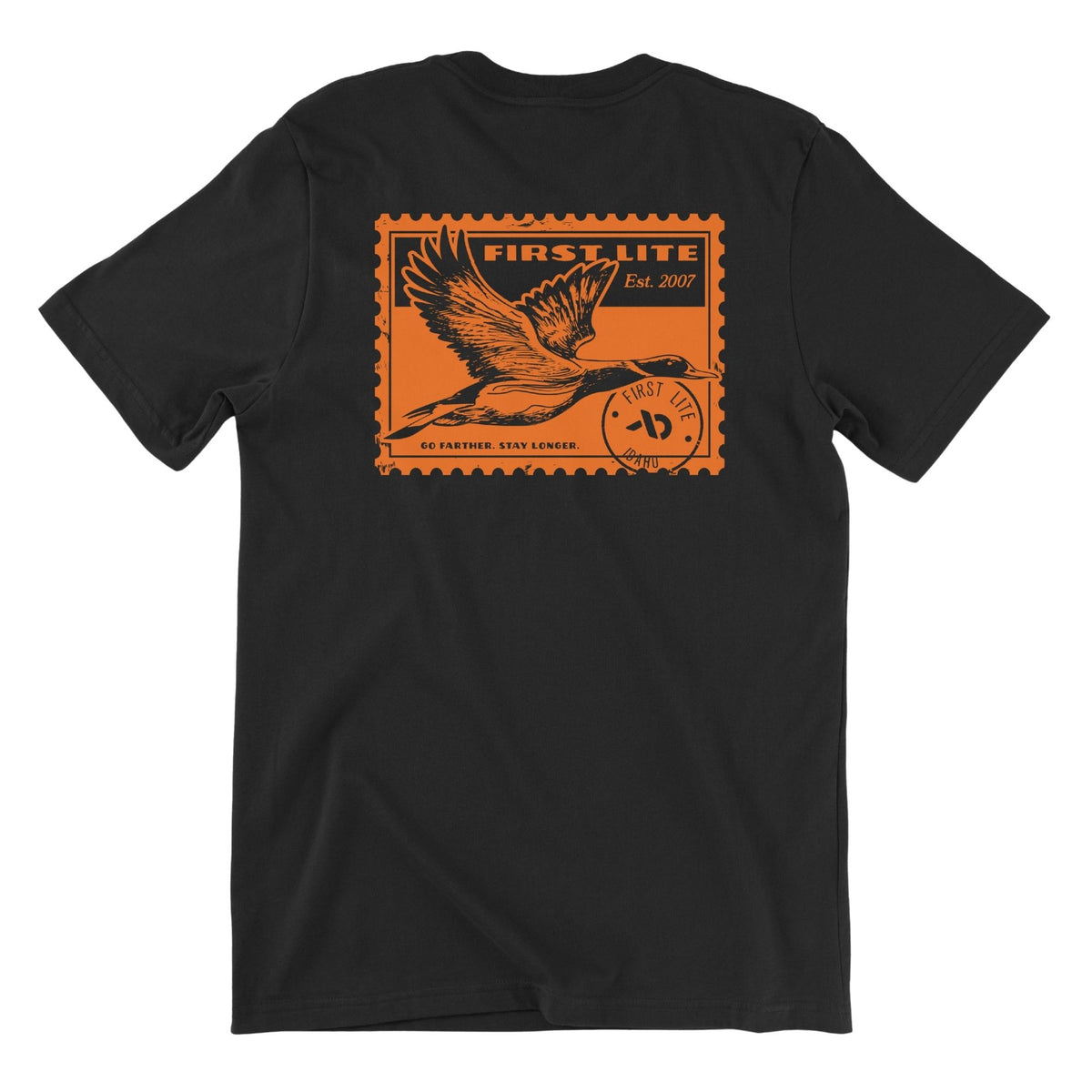 Black T-shirt featuring an orange postage stamp of a wild duck flying , FIRST LITE branding and the text "FIRST LITE EST. 2007 GO FATHER. STAY LONGER.".