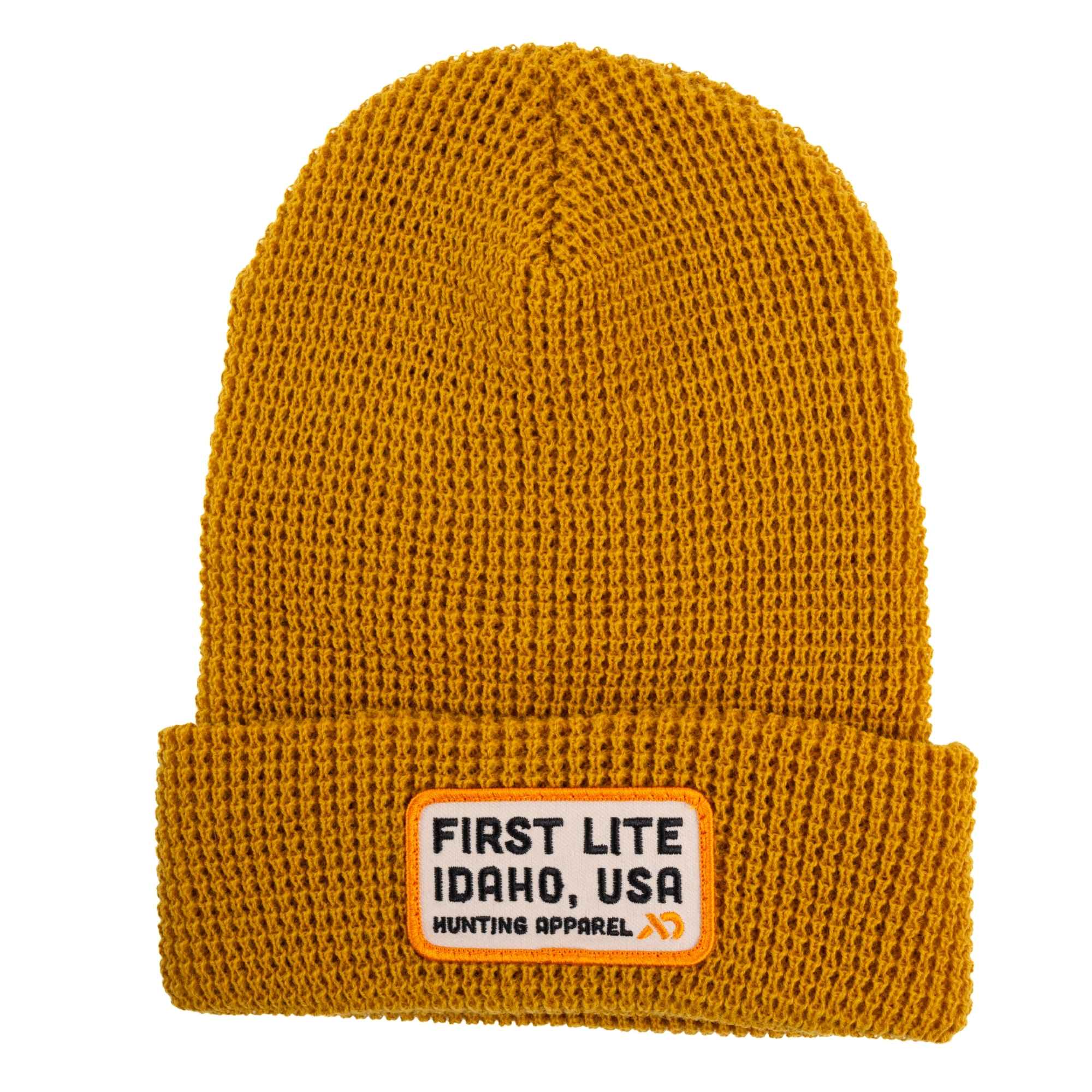 Camel ribbed knit beanie with a folded cuff and a beige square patch featuring the text "FIRST LITE IDAHO, USA Hunting Apparel"