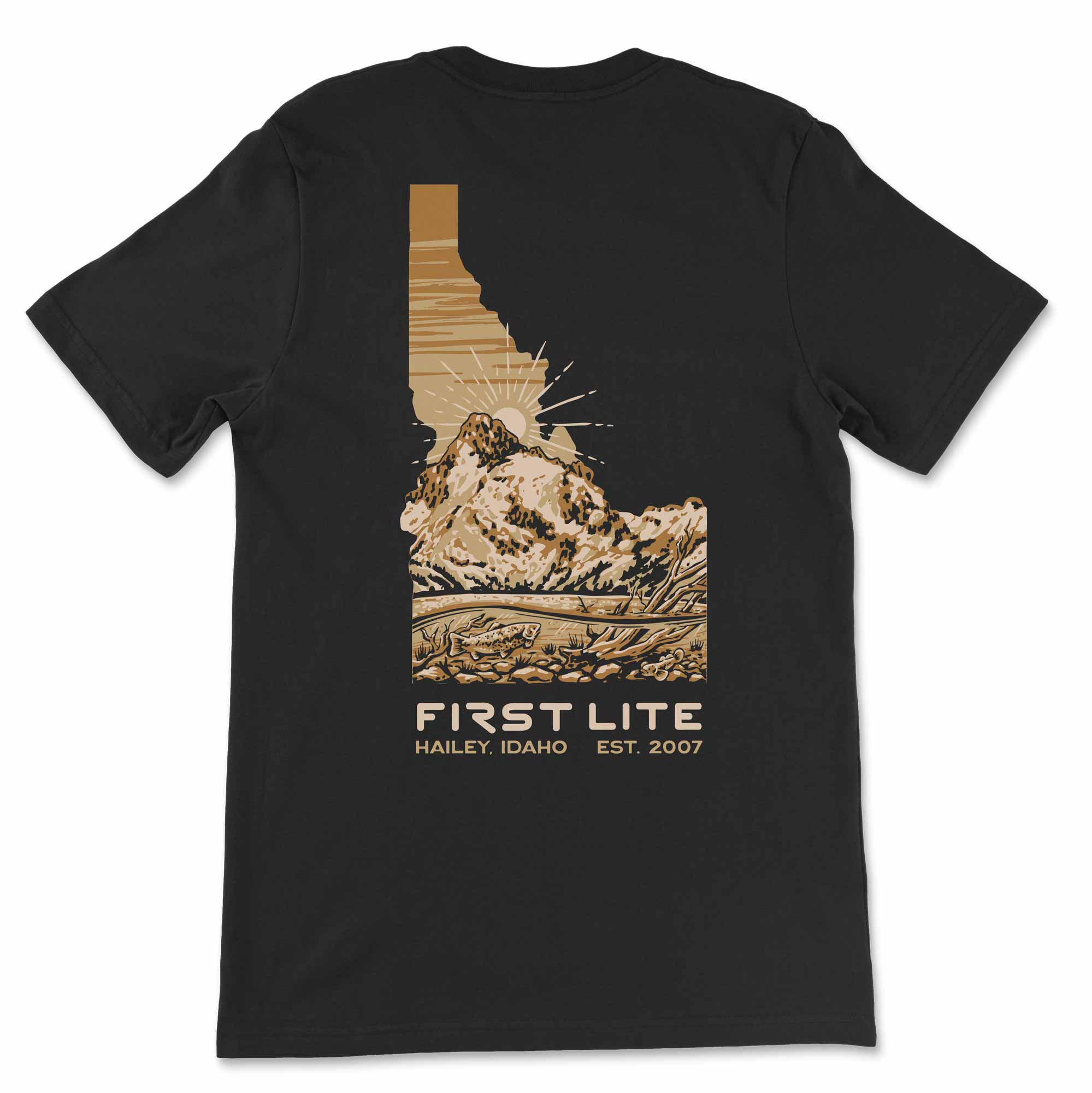 Black t-shirt with a mountain graphic and 'First Lite' branding on a white background