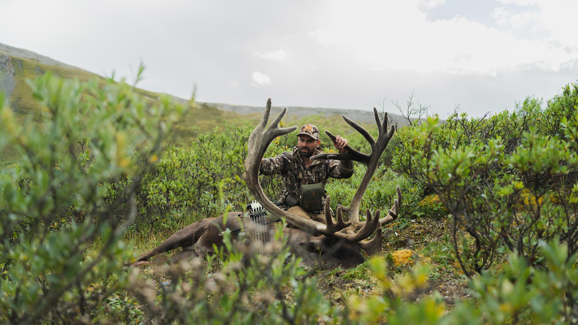 Remi Warren holding the antlers of a caribou. 