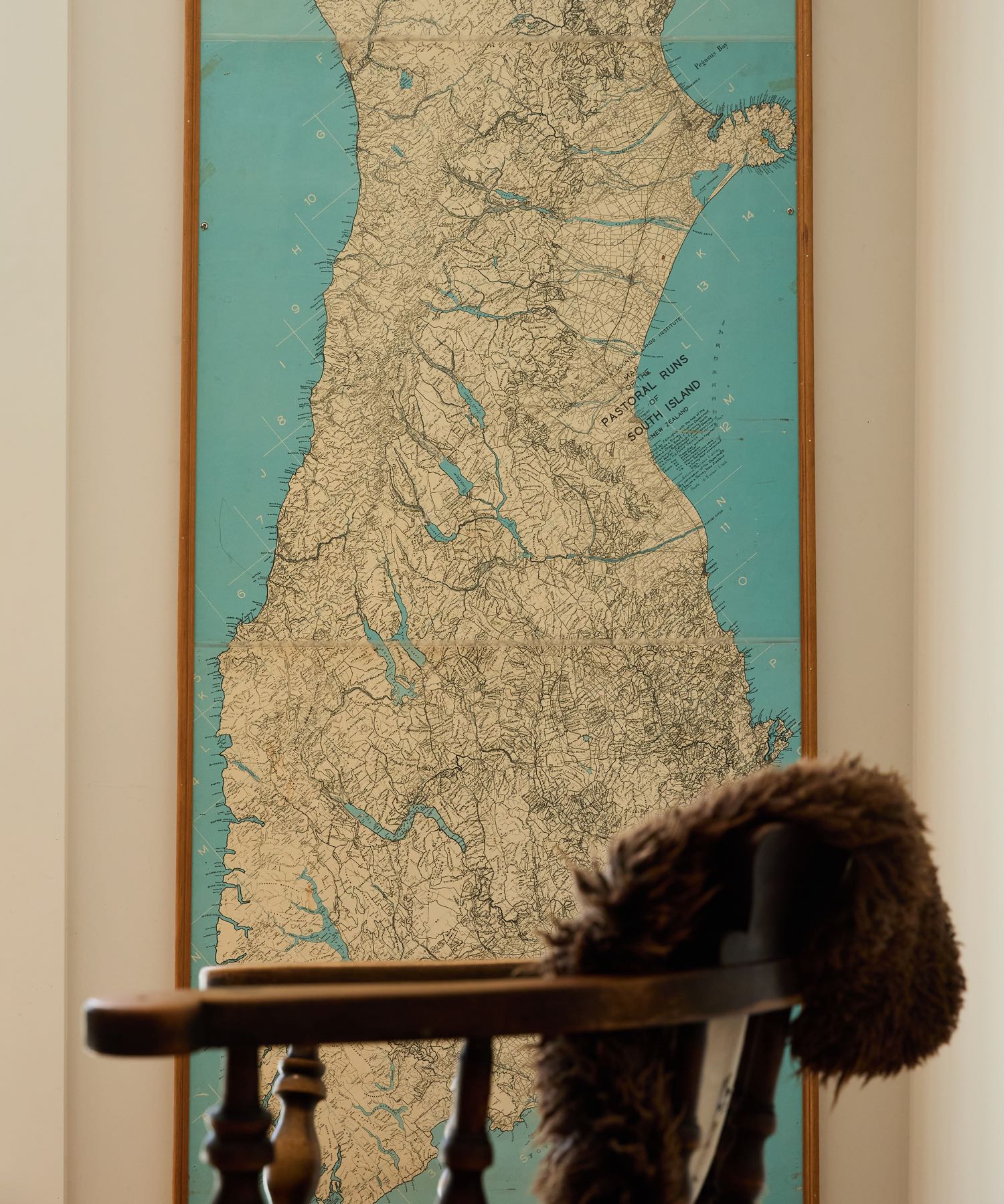 Vintage map of South Island, New Zealand, titled 'Pastoral Runs', with blue ocean and detailed land.